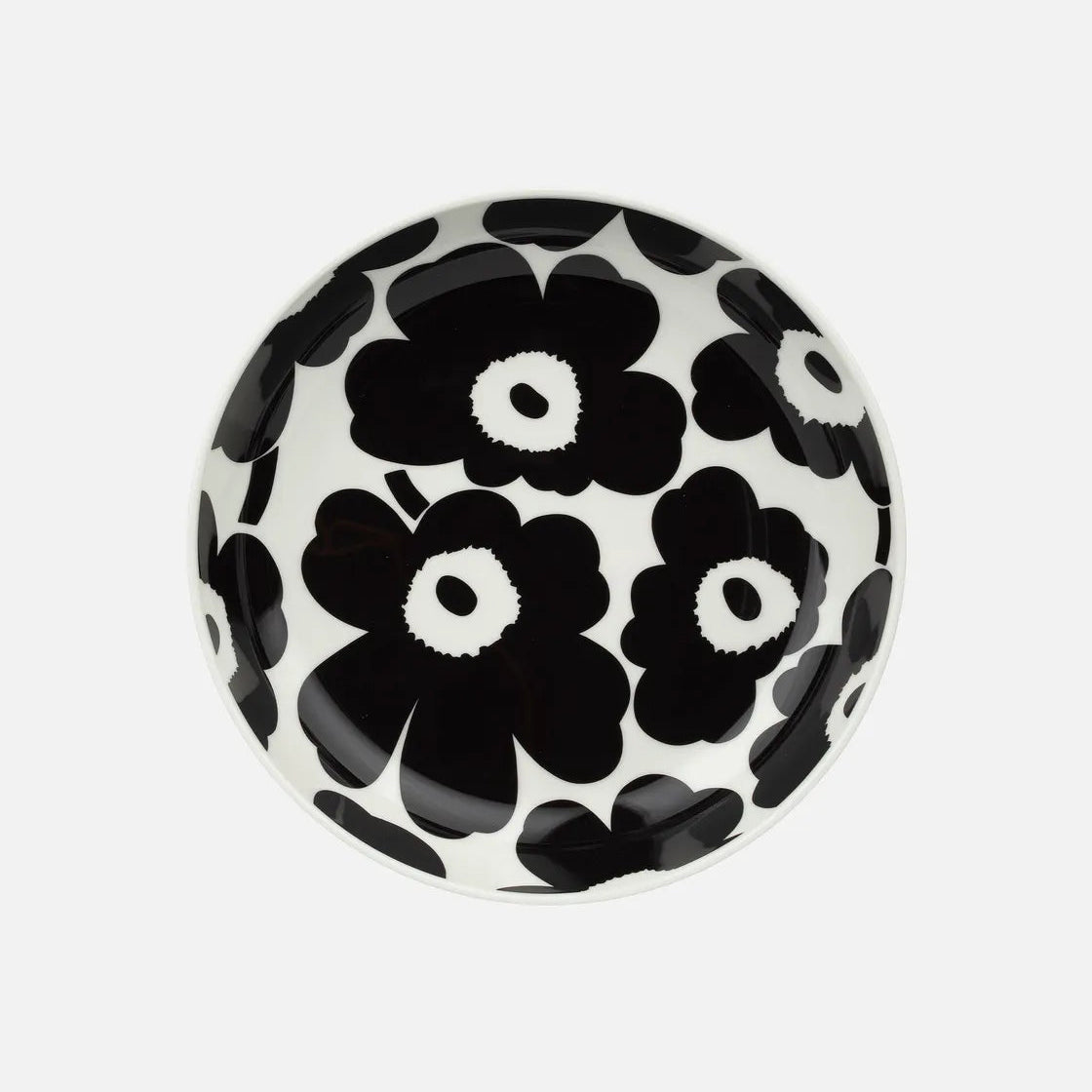 Black and white floral patterned ceramic plate on a white background