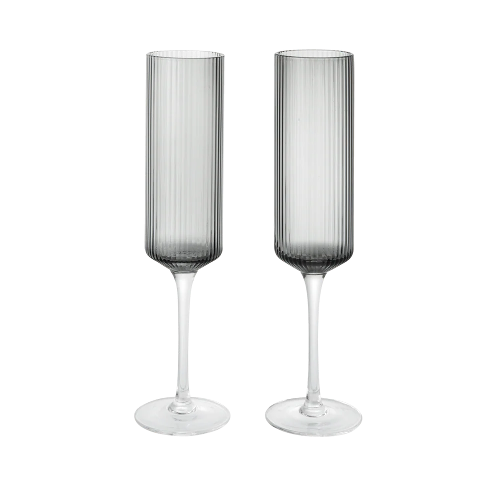 Two gray smoked champagne flutes on a white background