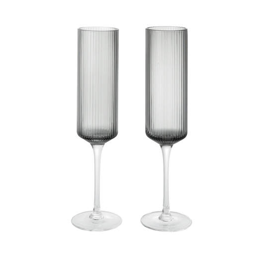 Two gray smoked champagne flutes on a white background