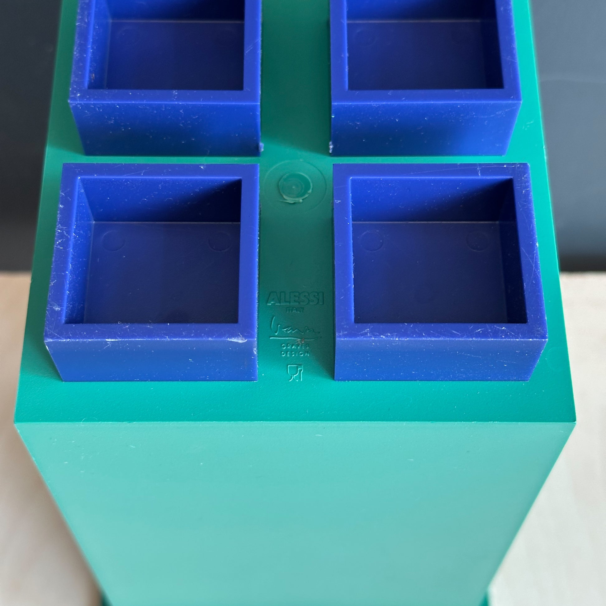 bottom of Michael Graves x Alessi green and blue wine holder/cannister