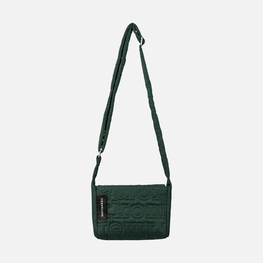 Green crossbody bag on a light gray background