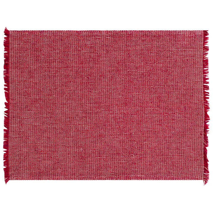 Red woven placemat with fringed edges on a white background