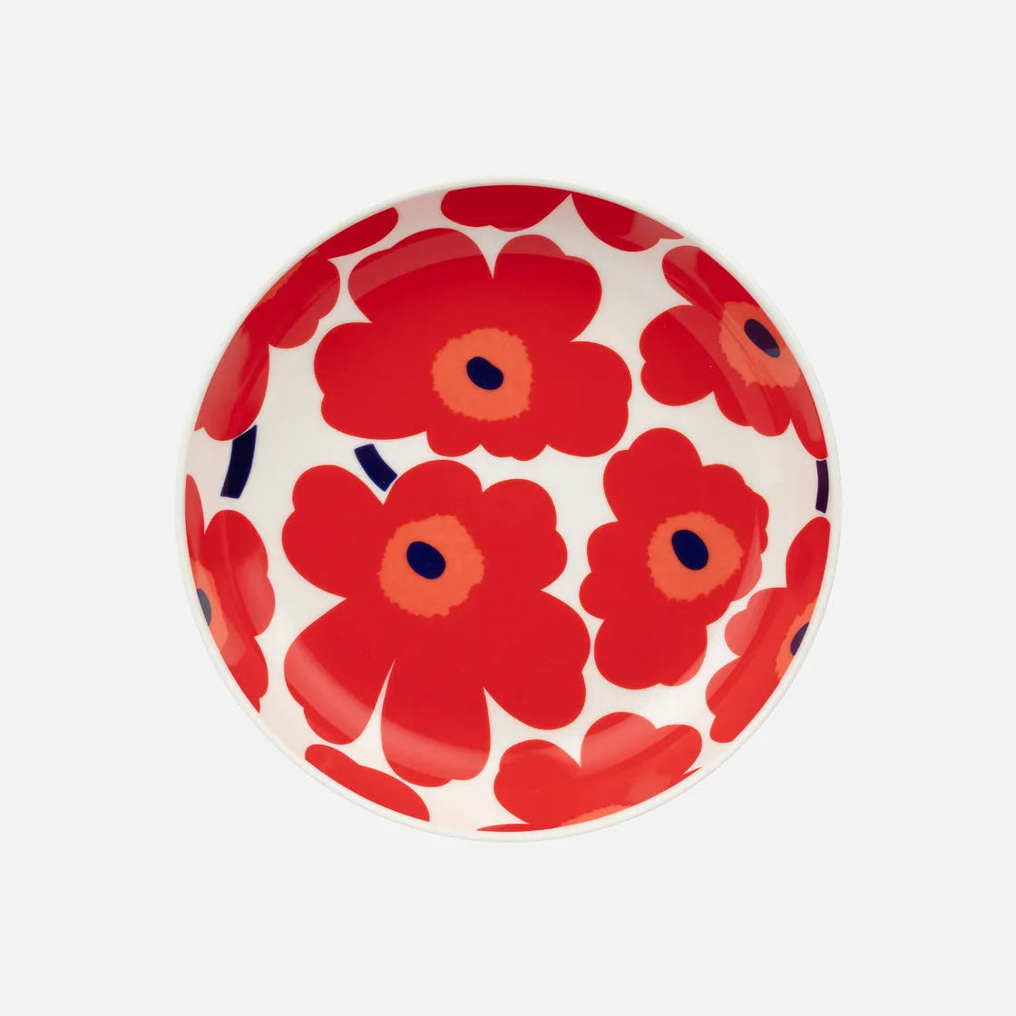 Round ceramic plate with red floral pattern on a white background