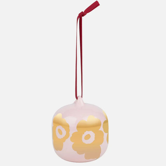 Decorative ornament with gold Unikko pattern on a pink background