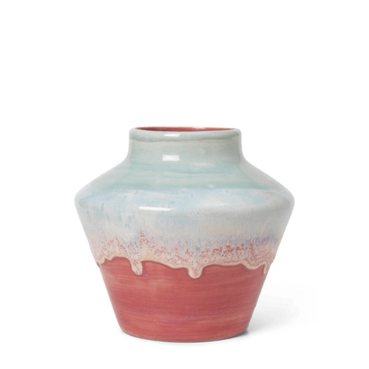 Ceramic vase with gradient color from light blue to pink on a white background