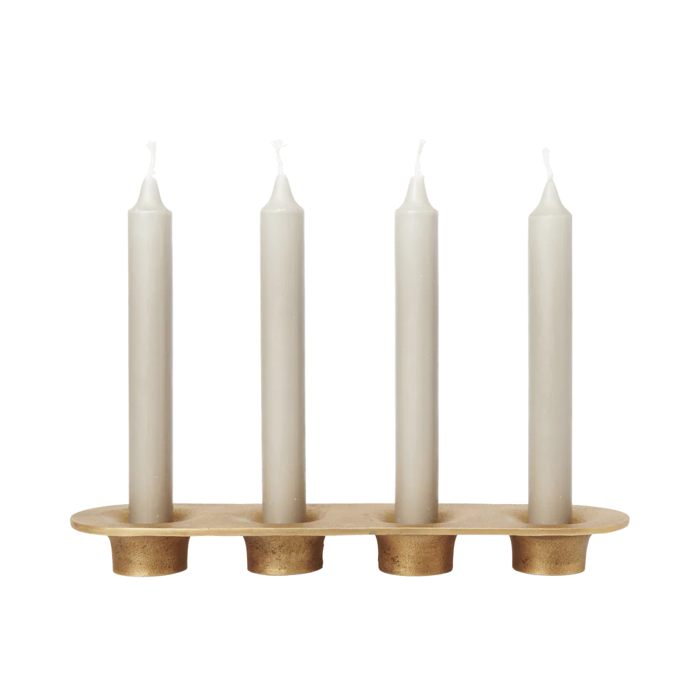 Candle holder with four white candles on a white background