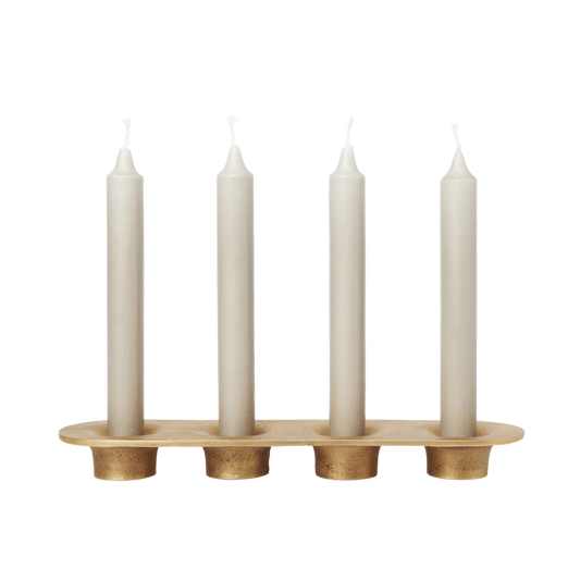 Candle holder with four white candles on a white background
