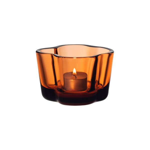 Orange colored wavy glass tealight candleholder.