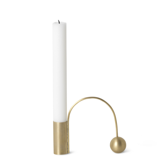 Brass candle holder with white candle.