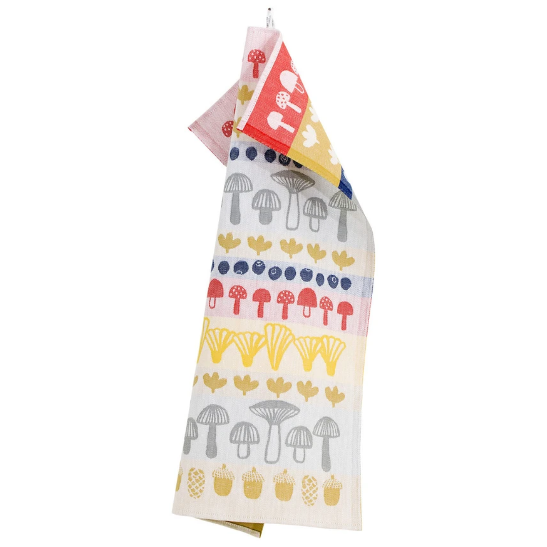 Towel with a red, blue, yellow, and grey mushroom pattern.