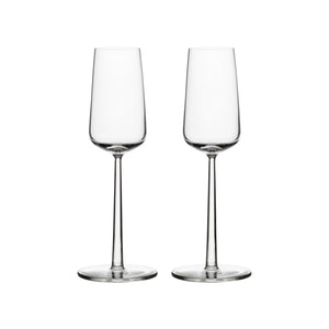 Two delicate champagne glasses against a white background.