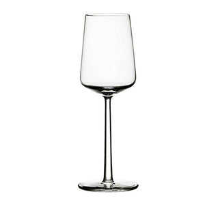 Delicate white wine glass against white background.