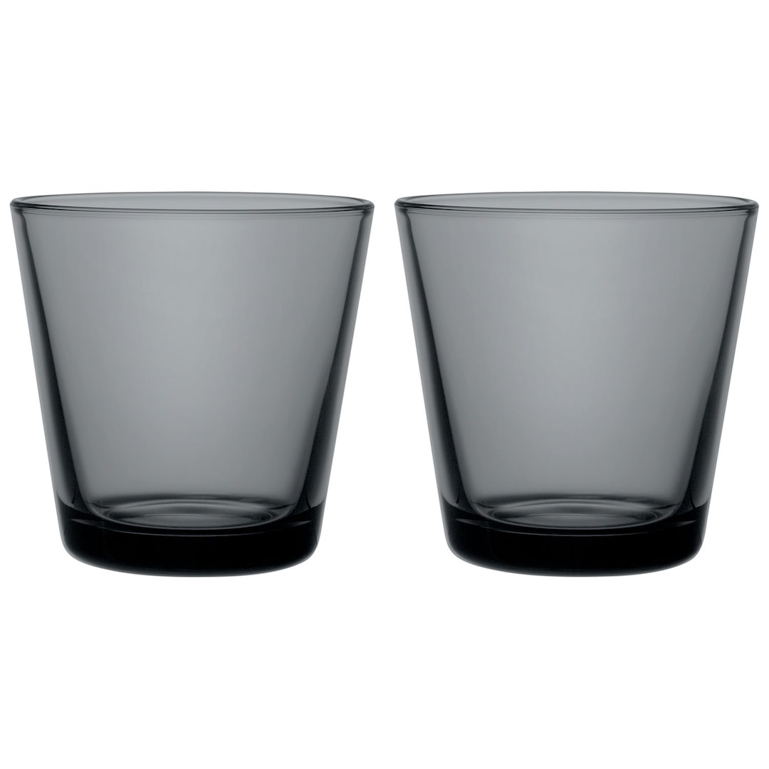 Dark grey colored glass tumblers on white background.