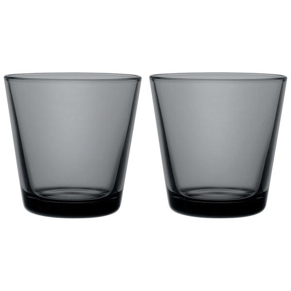 Dark grey colored glass tumblers on white background.